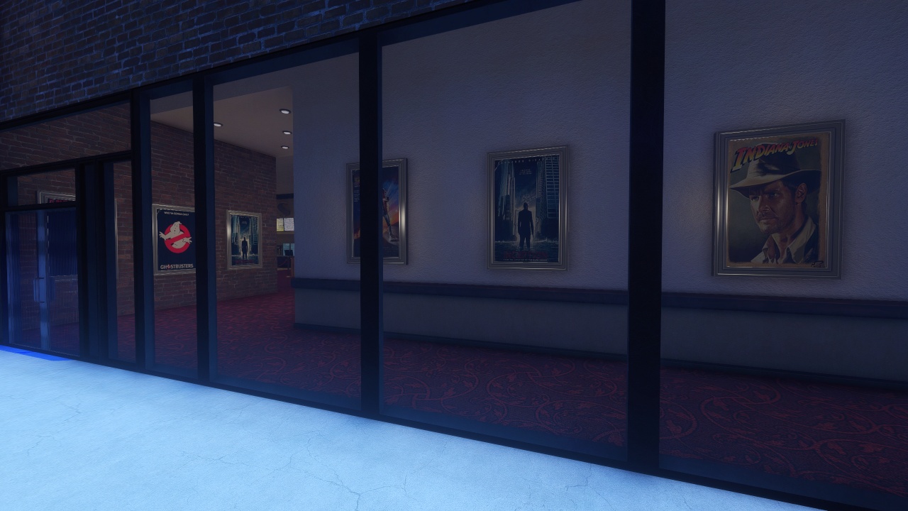 Strip mall exterior with glass wall entrance and promotional movie posters